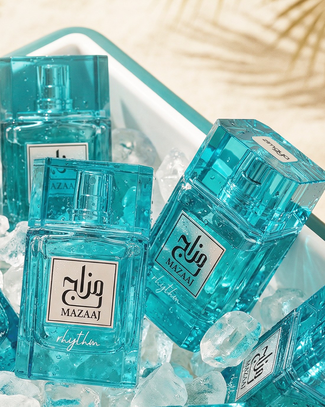 Turquoise Mazaaj Rhythm perfume bottles arranged among ice cubes — AI perfume imagery by The Media Lab.
