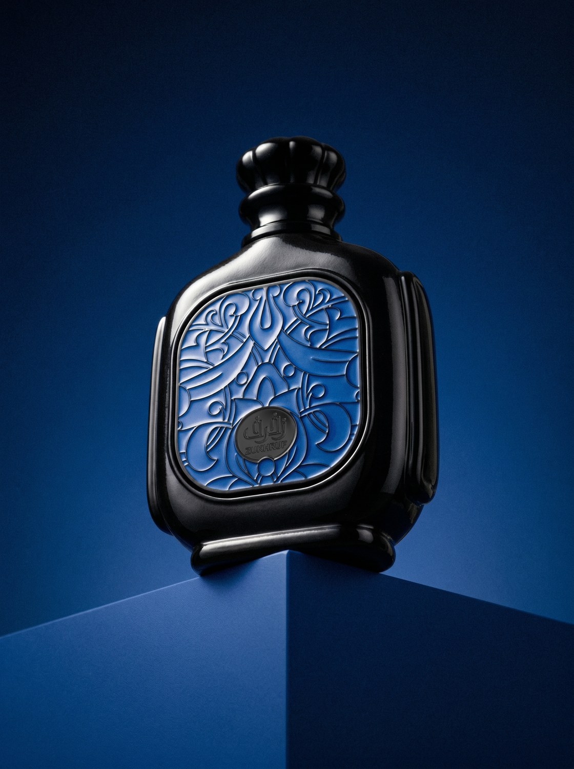 Zukhruf Homme blue perfume bottle above a geometric blue platform — AI perfume imagery by The Media Lab.
